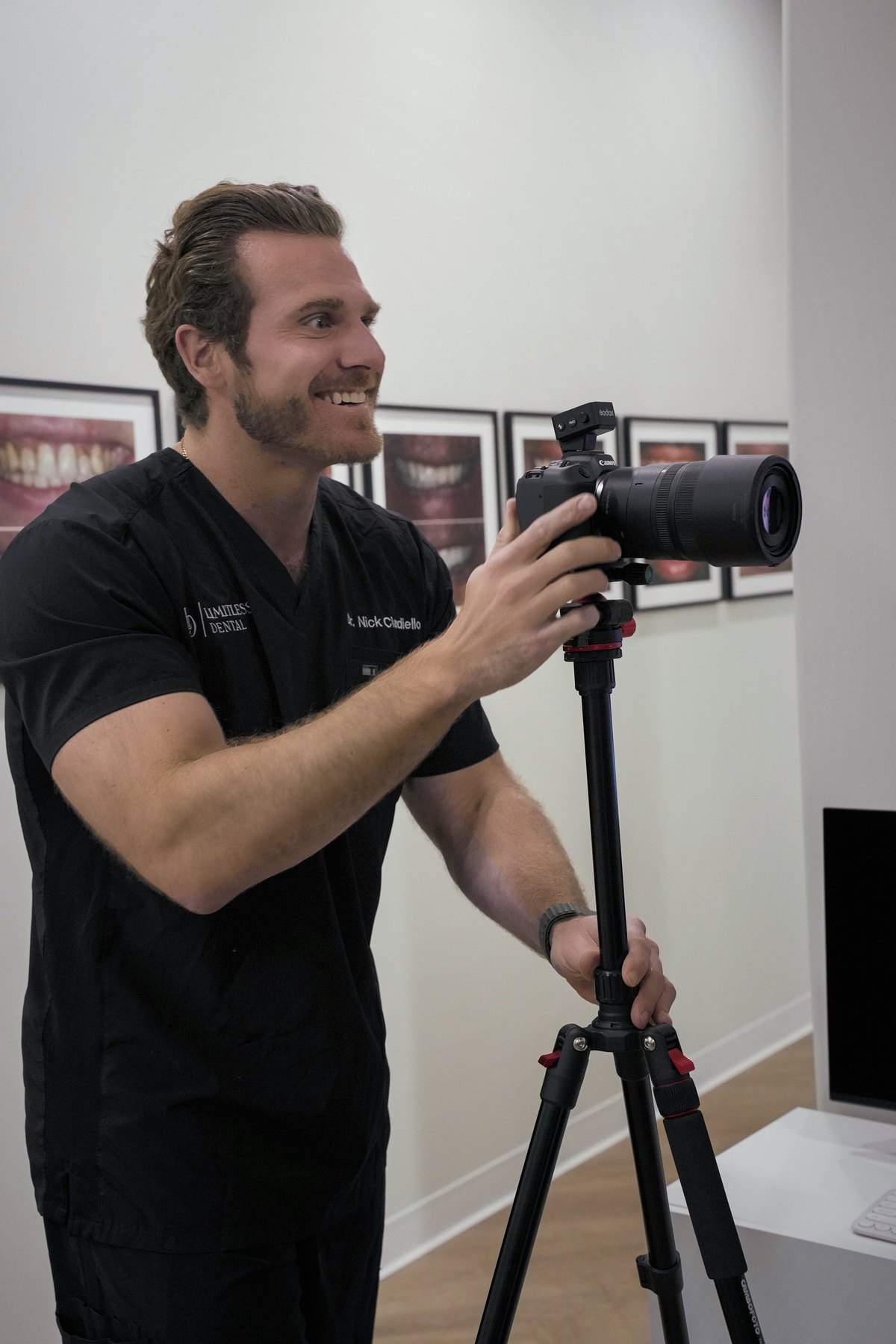 Dr. Nick Ciardiello laughing behind a camera on a tripod at Limitless Dental®